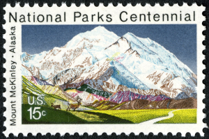 Postage stamp titled "National Parks Centennial" with a mountain range in the background.