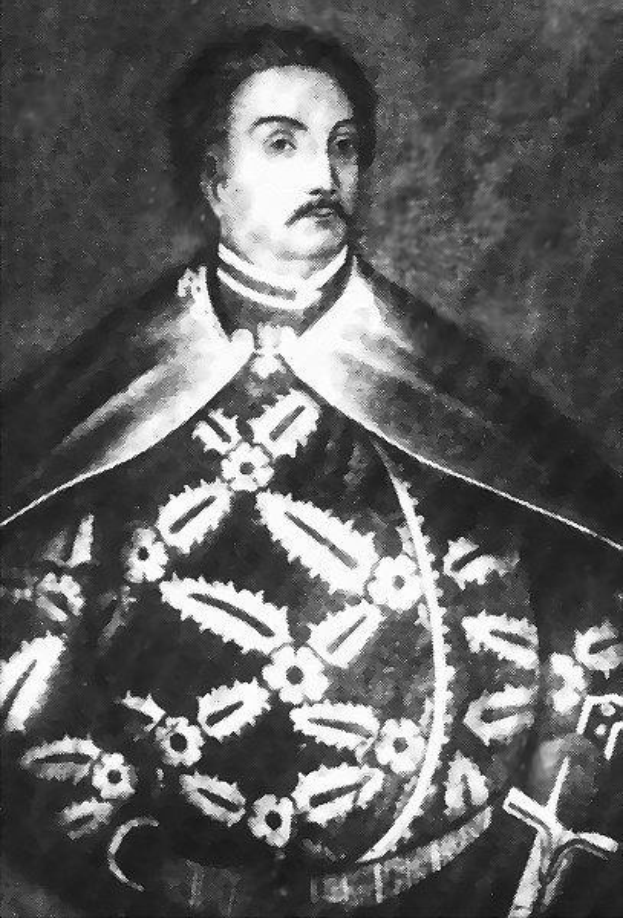 Schwarzes und weißes Foto von Papst Johannes Paul II. in Priesterkleidung, der eine schwarze Robe mit weißem Kragen und Manschetten trägt und die Hände verschränkt, mit einem strengen Gesichtsausdruck und direktem Blick.